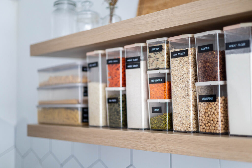 National Get Organized Month. Labeled food containers on a clean kitchen shelf.