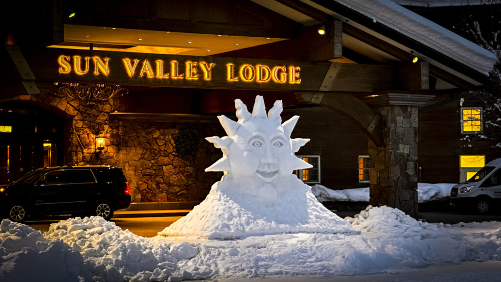 Traditional Sun Valley logo snow sculpture for the Winter 22-23 season, in front of the lodge entrance.