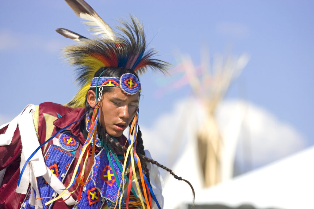 Post Falls, Idaho-July 14, 2009. A native American man in full dress dances at the Julyamsh powwow in northern Idaho