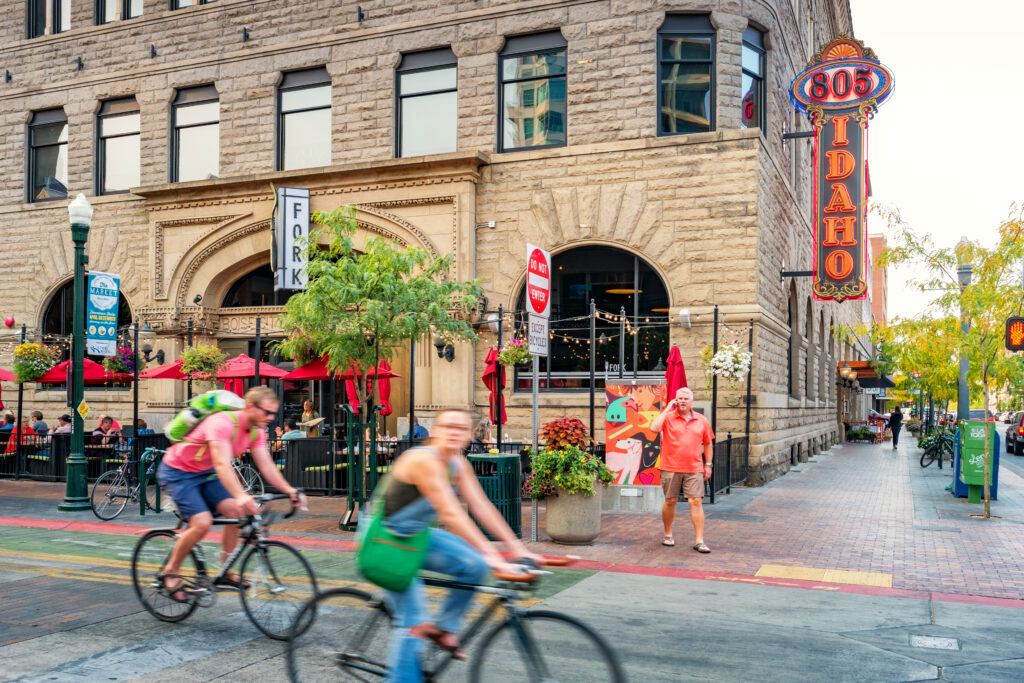 People bike in downtown Boise, Idaho, USA in the evening.