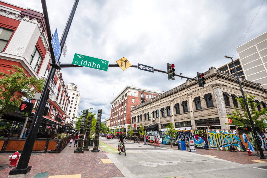 Boise, Idaho, USA - May 26, 2018: Bicycler waiting for the green light in the main street of Boise historic downtown.