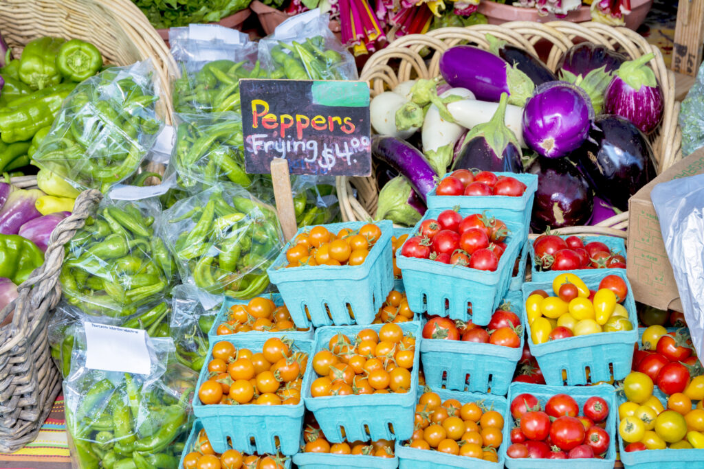 Tomatoes, peppers and eggplant at a farmers market
