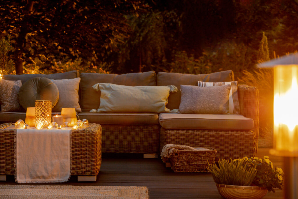 Wooden porch and rattan furniture on autumn warm evening
